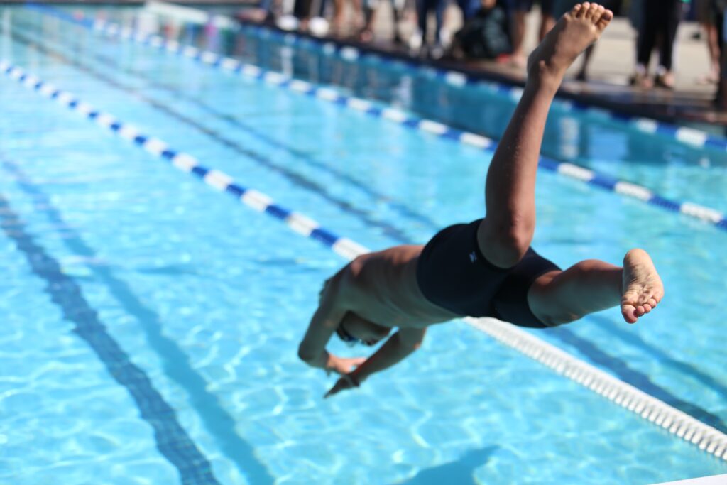 Image of a man jumping into a pool