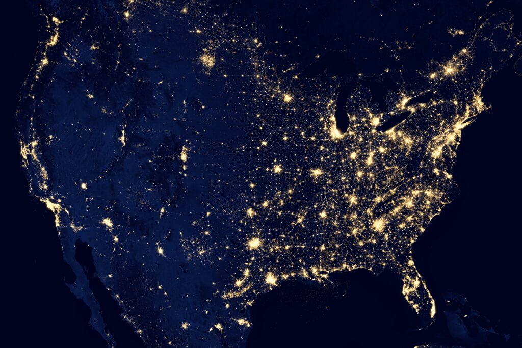 Aerial shot of north america being lit up by lights.